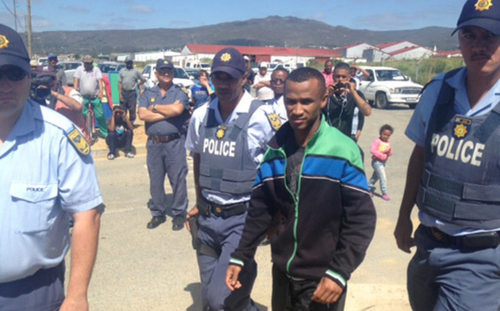 Kana arrives on the scene escorted by police. Pictrure: Renee de Villiers/EWN