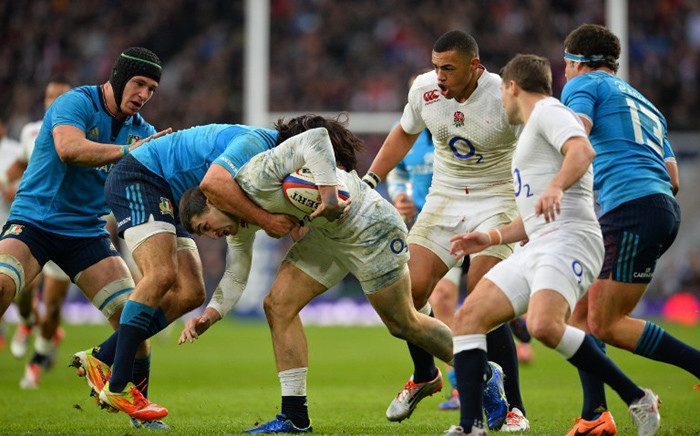 FILE: England’s wing Jonny May (C) is tackled during the Six Nations international rugby union match between England and Italy at Twickenham Stadium in south west London on 14 February, 2015. Picture: AFP