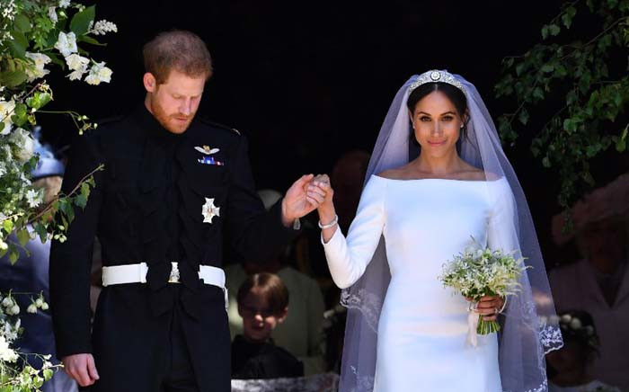 Britain's Prince Harry, Duke of Sussex and his wife Meghan, Duchess of Sussex emerge from the West Door of St George's Chapel, Windsor Castle, in Windsor, on 19 May 2018 after their wedding ceremony. Picture: AFP.