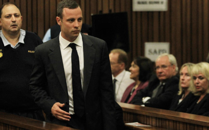 Oscar Pistorius walks past June Steenkamp as he entered Pretoria High Court ahead of the first day of his murder trial on 3 March 2014. Picture: Sapa.