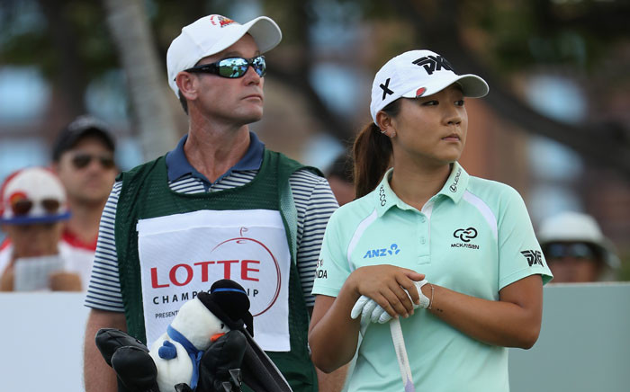 Lydia Ko of New Zealand stands with her caddie Gary Matthews and bag on the first hole during the final round of the LPGA LOTTE Championship Presented By Hershey at Ko Olina Golf Club on 15 April 2017 in Kapolei, Hawaii. Picture: AFP