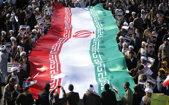 FILE: Iranians carry a giant flag. Picture: AFP
