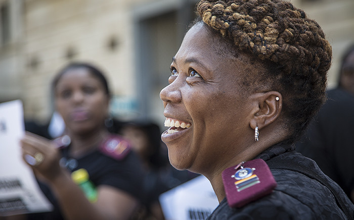 A nurse smiles during a march by hundreds of nurses from across the country in central Pretoria for better pay and working conditions. Picture: Reinart Toerien/EWN.