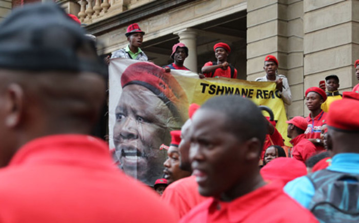 EFF members sing outside the North Gauteng High Court in Pretoria on 5 March. Picture: Sebabatso Mosamo/EWN.