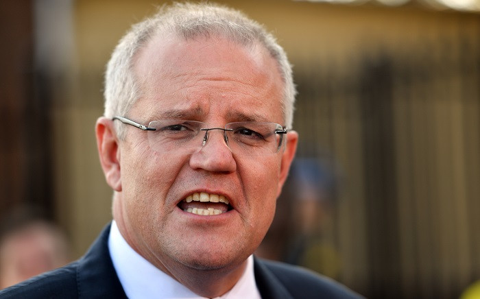 Australia's Prime Minister Scott Morrison talks to the media outside a polling booth during Australia's general election in Sydney on 18 May 2019. Picture: AFP