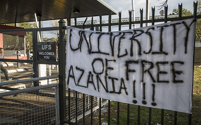 Protesting students at the University of the Free State placed a banner on a gate close to the entrance of the institution's main campus on 25 February 2016. Picture: Reinart Toerien/EWN.