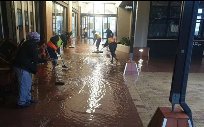 Workers mop up after heavy rainfall caused flooding at the Garden Route Mall in George on 22 November 2021. Picture: Storm Report SA/Facebook