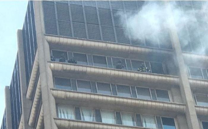 Five firefighters seen on the balcony of a burning building in Joburg. Picture: Christa Eybers/EWN