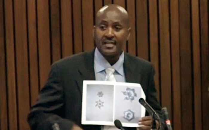 Ballistics expert Captain Mike Mangena gives testimony in court during the Oscar Pistorius murder trial on 19 March 2014.