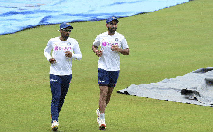FILE: Indian cricketers Wriddhiman Saha (L) and Cheteshwar Pujara run during a practice session ahead of the first test match between India and South Africa at the Dr. Y.S. Rajasekhara Reddy ACA-VDCA Cricket Stadium in Visakhapatnam on 30 September 2019. Picture: AFP