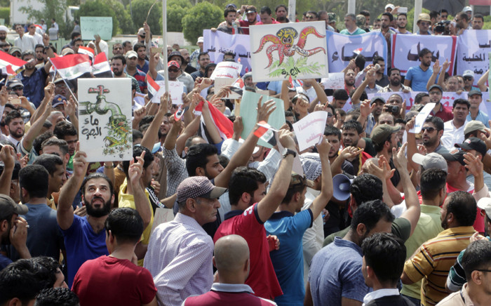 Iraqis shout slogans and hold placards during a demonstration to demand a solution to the long-running problem of salty tap water on 1 August, 2015 in the southern Iraqi city of Basra. Picture: AFP.