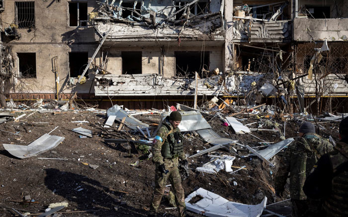 A Ukraine soldier inspects the rubble of a destroyed apartment building in Kyiv on 15 March 2022, after strikes on residential areas killed at least two people. Picture: FADEL SENNA/AFP