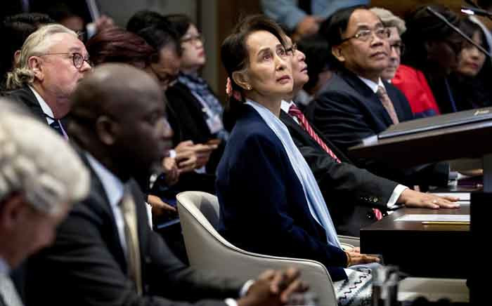 Myanmar's State Counsellor Aung San Suu Kyi (C) stands before the UN's International Court of Justice on 11 December 2019 next to Abubacarr Tambadou (2L), minister of justice of the Gambia, in the Peace Palace of The Hague, on the second day of her hearing on the Rohingya genocide case. Picture: AFP
