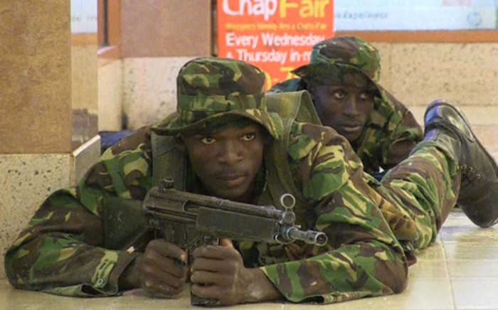 An image grab taken from AFP TV shows Kenyan troops taking position on September 21, 2013 inside the Westgate mall in Nairobi where Somali militants claimed responsibility for the killing of at least 59 people. Picture: NICHOLE SOBECKI/AFP.
