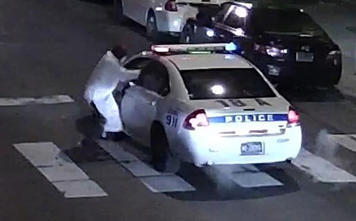 This video still image obtained 8 January, 2016 courtesy of the Philadelphia Police Department, shows a shooting suspect and police car on 7 January, 2016 in Philadelphia, PA. A self-professed sympathiser of the Islamic State extremist group shot and seriously wounded a police officer in Philadelphia, opening fire multiple times at point blank range with a stolen weapon. Picture: AFP.
