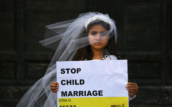 A young actress plays the role of Giorgia, 10, forced to marry Paolo, 47, during a happening organised by Amnesty International to denounce child marriage, on 27 October, 2016 in Rome. Picture: AFP.