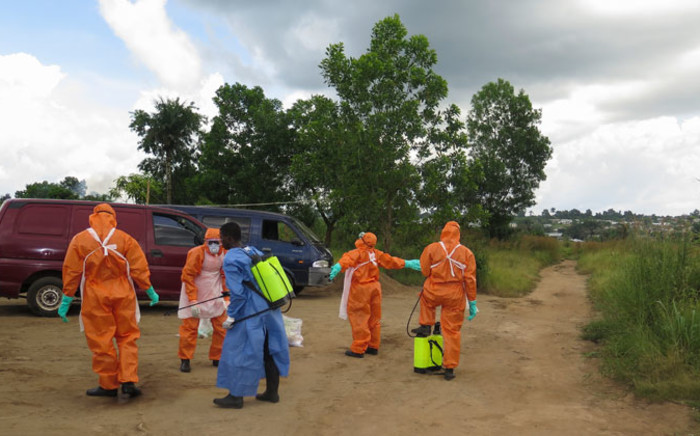 FILE: A Sierra Leone Red Cross burial team at Jobo Farm in Waterloo outside Freetown disinfects after recovering the bodies of those believed to have died of Ebola. Picture: EPA.