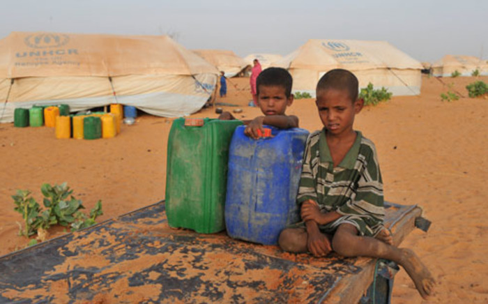 Malian refugee boys hold buckets of water in the refugee camp of M'bere near Bassikno, south east of Mauritania. Picture: AFP