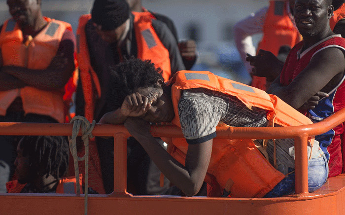 FILE: A Spanish coast guard boat with migrants onboard arrives at Malaga's harbour on 23 September 2018, after an inflatable boat carrying 117 immigrants, 34 of them women and 4 children, was rescued by the Spanish coast guard off the Spanish coast. Picture: AFP