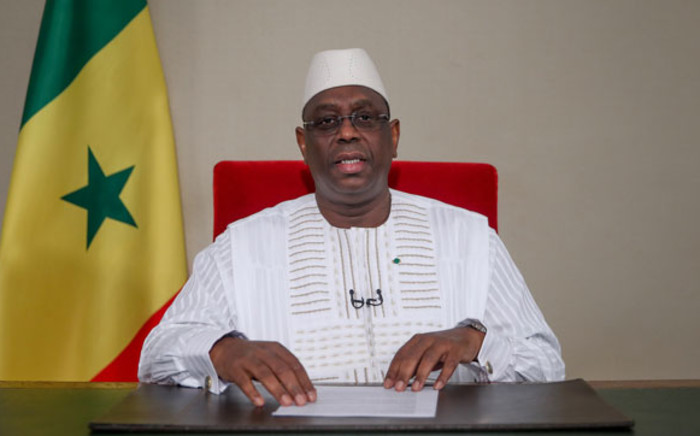 This hand out photo taken and distributed by Présidence Sénégal on 11 May 2020 shows Senegalese President Macky Sall announcing a softening of state emergency measures taken to curb the spread of the COVID-19 coronavirus during an address to the nation from the Presidential Palace in Dakar. Picture: AFP