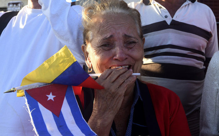 A woman cries as the urn with the ashes of Cuban leader Fidel Castro is driven through the streets of Havana. Picture: AFP.