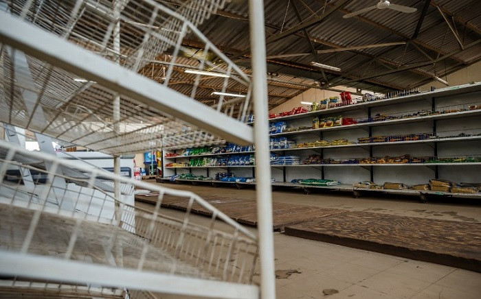 FILE: A picture shows empty shelves, including those for bread, in a grocery store in Harare on 9 October 2018, as Zimbabwe is experiencing renewed shortages. Picture: AFP