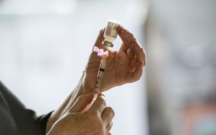 FILE: A healthcare worker fills a syringe with the Moderna COVID-19 vaccine Picture: AFP.