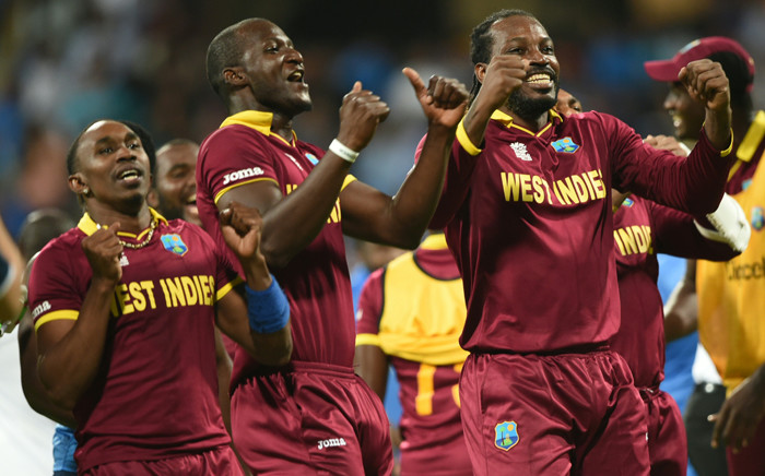West Indies’s captain Darren Sammy Dwayne Bravo and Chris Gayle celebrate after victory in the World T20 cricket tournament second semi-final match between India and West Indies at The Wankhede Stadium in Mumbai on 31 March, 2016. Picture: AFP.