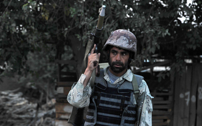 FILE: An Afghan soldier holds a rocket propelled grenade launcher following an attack by Taliban militants on the Afghan intelligence service office in Jalalabad on 30 August, 2014. Picture: AFP. 