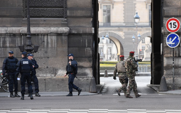 French police officers and soldiers patrol in front of the Louvre museum on February 3, 2017 in Paris after a soldier has shot and gravely injured a man who tried to attack him. Picture: AFP
