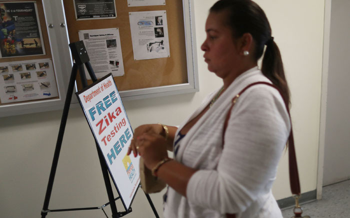 Krystal Cruz, who is pregnant, carries her urine sample as she gets a free Zika test from the Florida Department of Health. Picture: Getty Images/AFP.