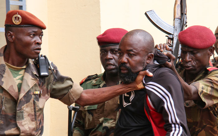 In this file photo taken on 29 October, 2018 members of the armed forces arrest Central African Republic MP Alfred Yekatom aka "Rambo" (C), who represents the southern M'baiki district former militia leader, after he fired the gun at the parliament in Bangui. Yekatom was extradited on 17 November 2018 to The Hague, The Netherlands, after an arrest warrant was issued by the International Criminal Court. Picture: AFP