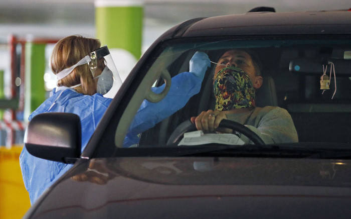 FILE: A Dis-Chem Pharmacy health professional collects a nasal swab for a COVID-19 coronavirus test at a drive-through testing site at a mall in Centurion on 9 April 2020. Picture: AFP
