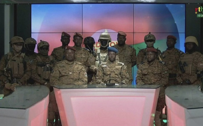 This video grab taken from a video obtained by AFPTV from Radio Télévision du Burkina (RTB) on January 24, 2022 shows Captain Sidsoré Kader Ouedraogo (C), spokesman for the junta, with uniformed soldiers announcing on television that they have taken power and 'put an end to the power' of Burkina Faso's President Roch Marc Christian Kaboré, in Ouagadougou. Soldiers in Burkina Faso on January 24, 2022 announced on state television that they have seized power in the West African country following a mutiny over the civilian president's failure to contain an Islamist insurgency. Picture: Radio Télévision du Burkina (RTB) / AFP
