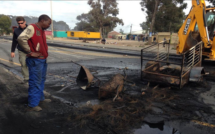 Andrew Mazarira’s business was looted and his belongings were stolen and set alight. He said he lost everything during the protest in Masiphumelele. Picture: Lauren Isaacs/EWN.
