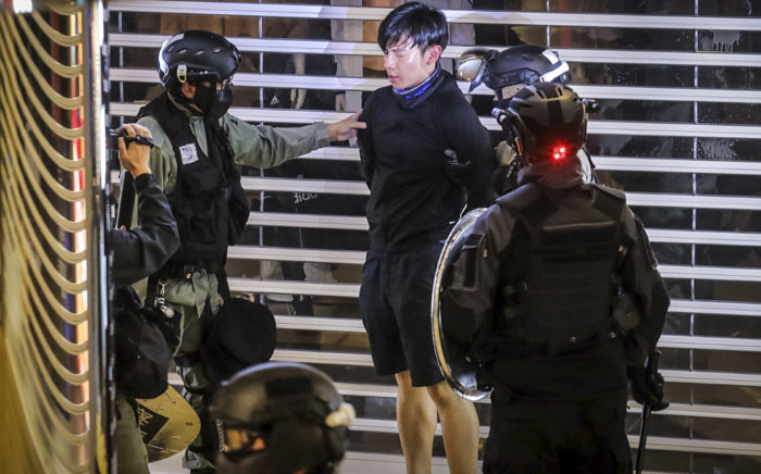 FILE: Riot police arrest a protester inside the City Plaza mall in the Tai Koo Shing area in Hong Kong on 3 November 2019. Picture: AFP