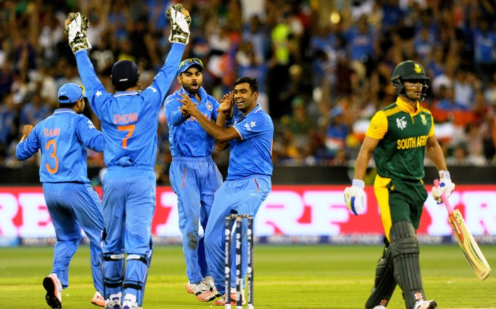 India's Ravichandran Ashwin (2nd R) celebrates with teammates after taking the wicket of South Africa's JP Duminy during the Pool B 2015 Cricket World Cup match between South Africa and India at the Melbourne Cricket Ground (MCG) on 22 February, 2015. Picture: AFP.