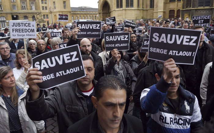 Protesters hold signs reading “Save Serge Atlaoui” on 25 April, 2015 during a rally near the city hall and cathedral of Metz, eastern France, in support of French national Serge Atlaoui, on death row in Indonesia for drug trafficking. Picture: AFP.