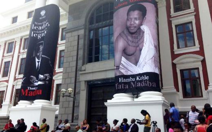 Images of Nelson Mandela adorn the pillars of Parliament in Cape Town. People filled the surrounding area to watch a special sitting to honour Madiba there on large screens, 9 December 2013. Picture: Carmel Loggenberg/EWN.