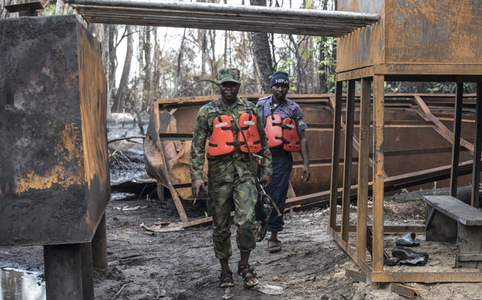 FILE: Members of the Nigerian Navy forces inspect a destroyed illegal oil refinery was on April 19, 2017 in the Niger Delta region near the city of Port Harcourt. Picture: AFP