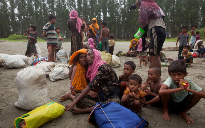 This undated photo shows newly arrived Rohingya refugees sit at Shamlapur beach in Cox's Bazar district, Bangladesh, after travelling for five hours in a boat across the open waters of the Bay of Bengal. Picture: Unicef.