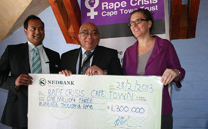 Social Development MEC Albert Fritz hands over a R1.3 million cheque to Rape Crisis on 28 February 2013. Picture: Supplied