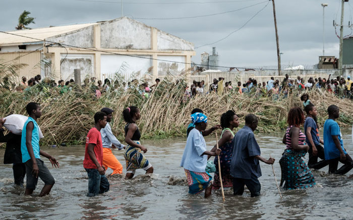 Displaced Mozambicans arrive at a warehouse for aid after Cyclone Idai hit the area, in Beira, Mozambique, on 20 March 2019. Picture: AFP
