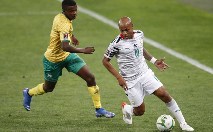 FILE: Ghana's Andre Ayew (R) fights for the ball with South Africa's Teboho Mokoena (L) during the FIFA World Cup Qatar 2022 qualifying round Group G football match between South Africa and Ghana at the FNB Stadium in Johannesburg on 6 September 2021. Picture: PHILL MAGAKOE/AFP