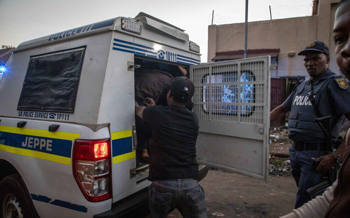 Suspects are loaded into a police van after being arrested for looting in Troyville, Johannesburg on 2 September 2019. Picture: Thomas Holder/EWN
