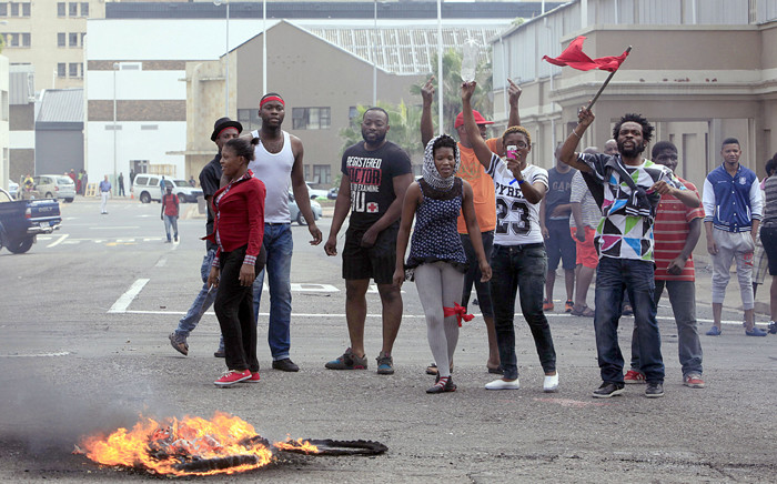 FILE: Foreign nationals gesture after clashes broke out between a group of locals and police in Durban on 14 April 2015 in ongoing violence against foreign nationals in Durban. Picture: AFP.