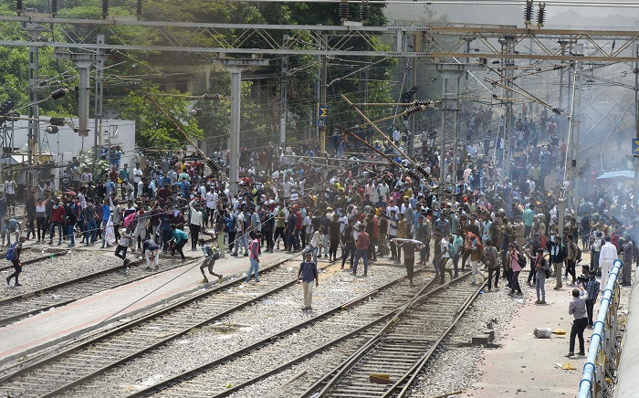 FILE: Hundreds of protesters stood on rail tracks in the southern city of Secunderabad, burning piles of debris to block passenger services and setting alight carriages on at least four trains. Picture: NOAH SEELAM / AFP