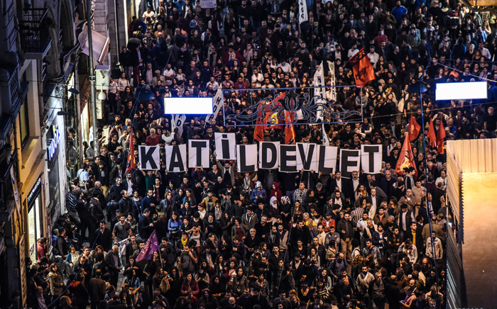 Placards reading "Killer state" are seen as thousands of protesters take part in a march against the deadly attack earlier in Ankara on October 10, 2015 at the Istiklal avenue in Istanbul. At least 86 people were killed on October 10 in the Turkish capital Ankara when bombs set off by two suspected suicide attackers ripped through leftist and pro-Kurdish activists gathering for an anti-government peace rally, the deadliest attack in the history of modern Turkey. Picture: AFP.