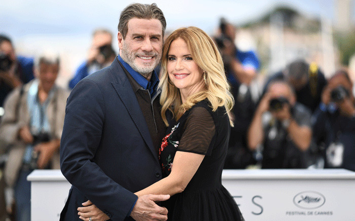 In this file photo taken on 15 May 2018 US actor John Travolta (L) and his wife US actress Kelly Preston pose during a photocall for the film "Gotti" at the 71st edition of the Cannes Film Festival in Cannes, southern France. Kelly Preston, US actress and wife of US actor John Travolta, died after a battle with breast cancer at the age of 57, US media reported on 12 July 2020. Picture: AFP