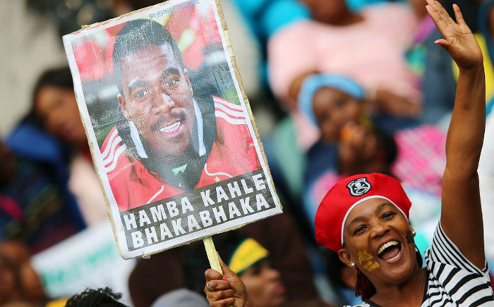 South African supporters hold a portrait of murdered Bafana Bafana captain and goalkeeper Senzo Meyiwa during the Africa Cup of Nations 2015 qualifying football match South Africa vs Sudan, at the Moses Mabhida Stadium in Durban, on 15 November, 2014. Picture: AFP